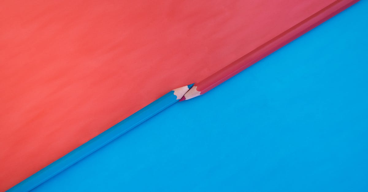 Abstract composition featuring red and blue pencils on contrasting red and blue backgrounds