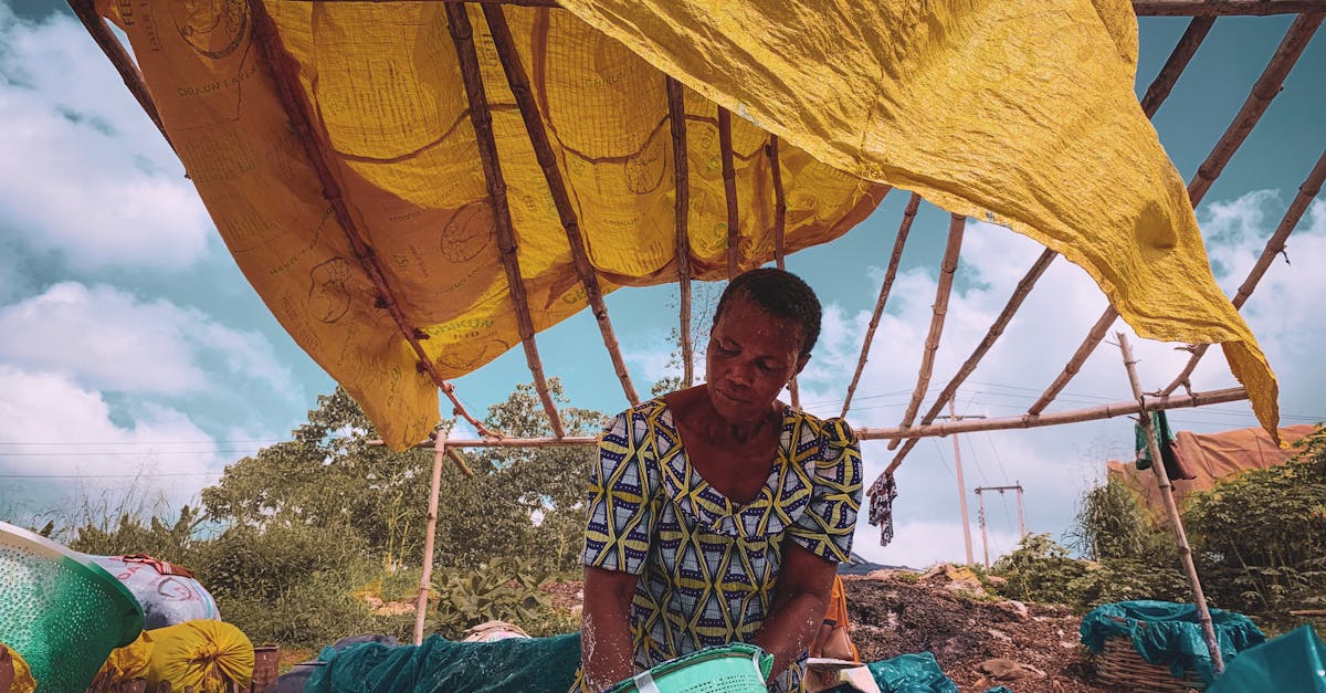 Elderly woman working under a makeshift tent in egbado south nigeria showcasing local lifestyle