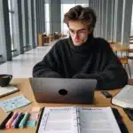 Student in norway outlining thesis structure on laptop with imrad notes